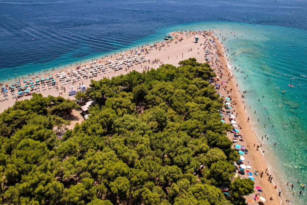 Stunning aerial view of the famous Zlatni Rat Beach with turquoise waters, ideal for summer vacations.